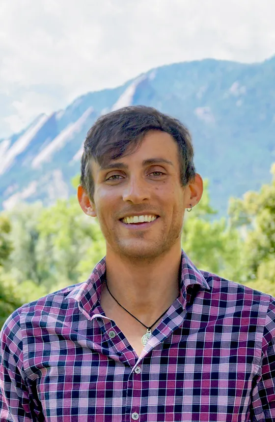 Dan Entmacher outdoors with mountains behind him