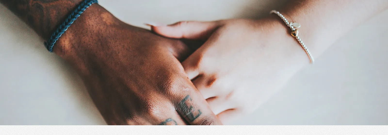 Two hands gently resting on each other